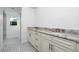 Elegant bathroom with double vanity and patterned tile floor at 8099 Walbert St, Port Charlotte, FL 33981