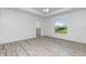 Spacious bedroom featuring wood-look floors and backyard view at 8099 Walbert St, Port Charlotte, FL 33981