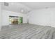 Bright living room with vinyl plank flooring, ceiling fan, and sliding glass doors leading to the patio at 8099 Walbert St, Port Charlotte, FL 33981