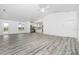 Spacious living area with wood-look vinyl flooring and an open view to the kitchen at 8099 Walbert St, Port Charlotte, FL 33981