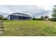 House exterior and grassy backyard at 8099 Walbert St, Port Charlotte, FL 33981