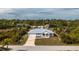 Single-story home, metal roof, paved driveway, and backyard at 8099 Walbert St, Port Charlotte, FL 33981