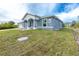One story home with a light blue exterior at 8099 Walbert St, Port Charlotte, FL 33981