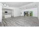 Spacious living area with wood-look flooring and sliding glass doors at 8099 Walbert St, Port Charlotte, FL 33981