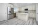 Modern kitchen with white cabinets, stainless steel appliances, and an island at 8099 Walbert St, Port Charlotte, FL 33981