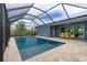 Large screened pool with patio and dining area at 8099 Walbert St, Port Charlotte, FL 33981