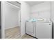 Bright laundry room with washer, dryer, and additional storage at 8099 Walbert St, Port Charlotte, FL 33981