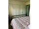 Bedroom with built-in closet and metal bed frame at 72 Boundary Blvd # 224, Rotonda West, FL 33947