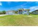 Two-car garage home with nicely landscaped lawn at 9293 Panama Cir, Port Charlotte, FL 33981