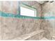 Large walk-in shower with tiled walls and built-in seat at 9293 Panama Cir, Port Charlotte, FL 33981