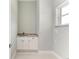 Laundry area with granite countertop and white cabinets at 9293 Panama Cir, Port Charlotte, FL 33981