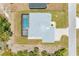 Aerial view showing house, pool, and surrounding landscape at 9293 Panama Cir, Port Charlotte, FL 33981