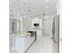 Modern kitchen with white cabinets, granite countertops, and a farmhouse sink at 9293 Panama Cir, Port Charlotte, FL 33981