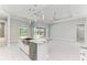 Open kitchen features a large island with granite countertops and stainless steel appliances at 9293 Panama Cir, Port Charlotte, FL 33981