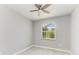 Bedroom with window, ceiling fan, and wood-look floors at 9293 Panama Cir, Port Charlotte, FL 33981