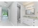 Bathroom features a toilet, vanity, and access to other rooms at 9293 Panama Cir, Port Charlotte, FL 33981