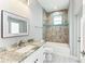 Bathroom with tub, vanity, and window at 9293 Panama Cir, Port Charlotte, FL 33981