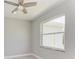Bright bedroom with large window and ceiling fan at 9293 Panama Cir, Port Charlotte, FL 33981