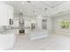 Modern kitchen with white cabinets, granite island, and stainless steel appliances at 9293 Panama Cir, Port Charlotte, FL 33981