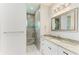 Modern bathroom with a walk-in shower, pebble floor, and granite vanity at 9293 Panama Cir, Port Charlotte, FL 33981