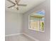 Bedroom with ceiling fan and large window at 14999 Wichita Rd, Port Charlotte, FL 33981