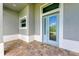 Light teal front door with glass and decorative accents at 14999 Wichita Rd, Port Charlotte, FL 33981