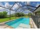 Inviting screened pool and lanai with ample space for relaxation and entertainment at 14999 Wichita Rd, Port Charlotte, FL 33981
