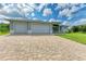 New construction home with three-car garage and paver driveway at 14999 Wichita Rd, Port Charlotte, FL 33981