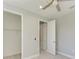 Bright bedroom with ceiling fan, walk-in closet, and neutral decor at 14999 Wichita Rd, Port Charlotte, FL 33981