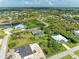 Aerial view showcasing a desirable neighborhood with water access and numerous properties at 14999 Wichita Rd, Port Charlotte, FL 33981