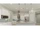 Modern kitchen with white cabinets, granite island, and pendant lighting at 14999 Wichita Rd, Port Charlotte, FL 33981