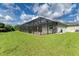 Relaxing backyard oasis featuring a screened pool and lush landscaping at 14999 Wichita Rd, Port Charlotte, FL 33981