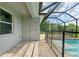 Side view of the pool and patio area with a screened enclosure at 14999 Wichita Rd, Port Charlotte, FL 33981