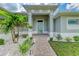 Front entry with walkway, landscaping, and light gray walls at 14999 Wichita Rd, Port Charlotte, FL 33981