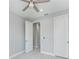 Well-lit bedroom with ceiling fan and access to hallway bathroom at 14999 Wichita Rd, Port Charlotte, FL 33981
