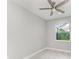Spacious bedroom with ceiling fan and large window overlooking the backyard at 14999 Wichita Rd, Port Charlotte, FL 33981