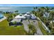 Stunning waterfront home with circular driveway, lush landscaping, and private dock at 12440 Placida Rd, Placida, FL 33946