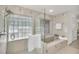 Clean bathroom with a walk-in shower and a bathtub at 12440 Placida Rd, Placida, FL 33946