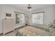 Cozy bedroom with twin beds, dresser, and ceiling fan at 12440 Placida Rd, Placida, FL 33946