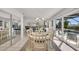 Elegant dining room with a table for six and access to the pool and kitchen at 12440 Placida Rd, Placida, FL 33946