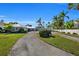 Luxury waterfront home with a long private driveway and lush landscaping at 12440 Placida Rd, Placida, FL 33946
