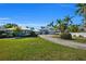 Luxury waterfront home with a long private driveway and lush landscaping at 12440 Placida Rd, Placida, FL 33946