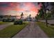 House exterior at sunset with a long driveway at 12440 Placida Rd, Placida, FL 33946