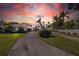 House exterior at sunset with a long driveway at 12440 Placida Rd, Placida, FL 33946