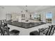 Updated kitchen featuring a large island with seating and water views at 12440 Placida Rd, Placida, FL 33946