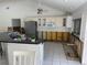 A kitchen with a breakfast bar, in need of renovation at 12440 Placida Rd, Placida, FL 33946