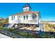 Elevated lighthouse on stilts with stairs to beach access at 12440 Placida Rd, Placida, FL 33946