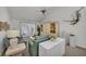 Spacious living room with a teal couch and high ceilings at 12440 Placida Rd, Placida, FL 33946