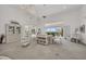 Bright living room with spiral staircase, water views, and comfortable seating at 12440 Placida Rd, Placida, FL 33946