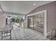 Tiled patio with glass doors opening to bedroom and pool at 12440 Placida Rd, Placida, FL 33946
